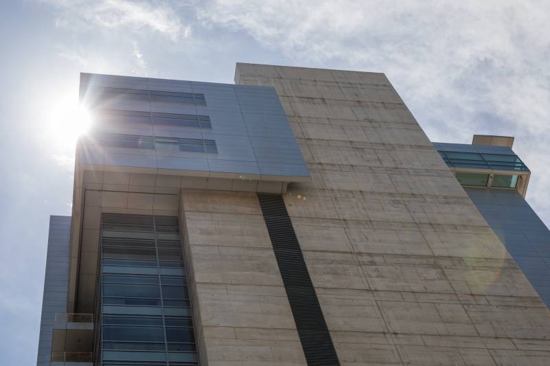 A large modern office building seen from below.